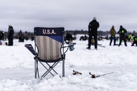 A chair and fishing rods on the snow at The Brainerd Jaycees Ice Fishing Extravaganza.jpg